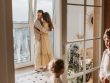 A joyful family moment with parents and children cuddling indoors during the day.