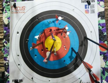 a close up of a target with arrows in it
